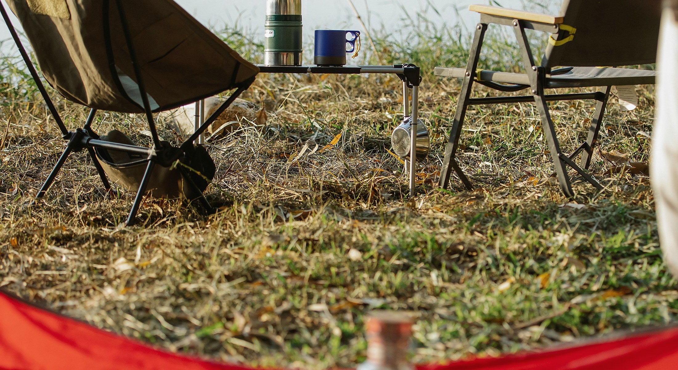 Portable camping furniture beside a lake