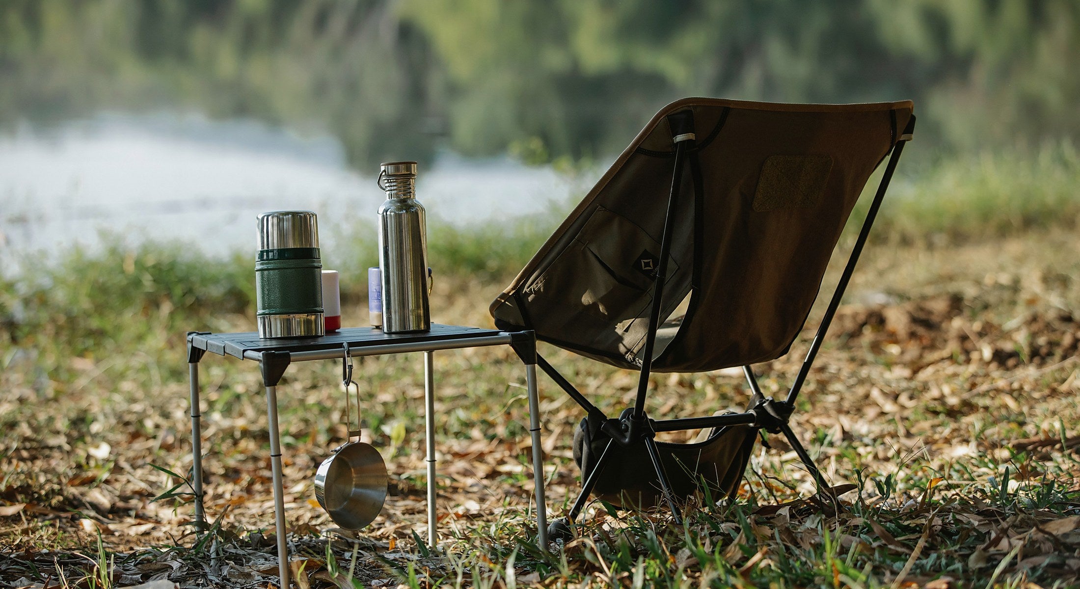 Portable camping furniture beside a lake