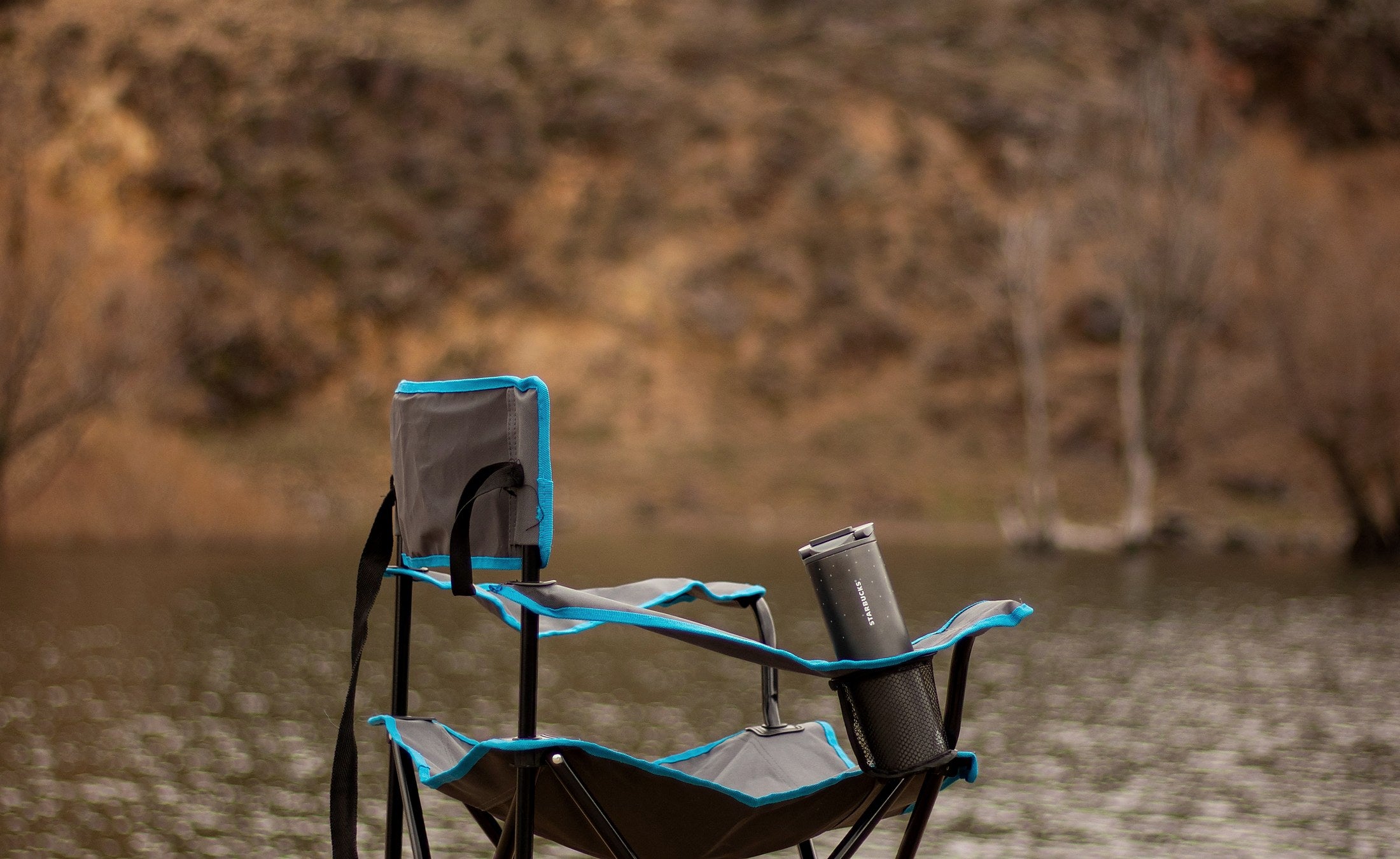 Portable camping chair beside a river