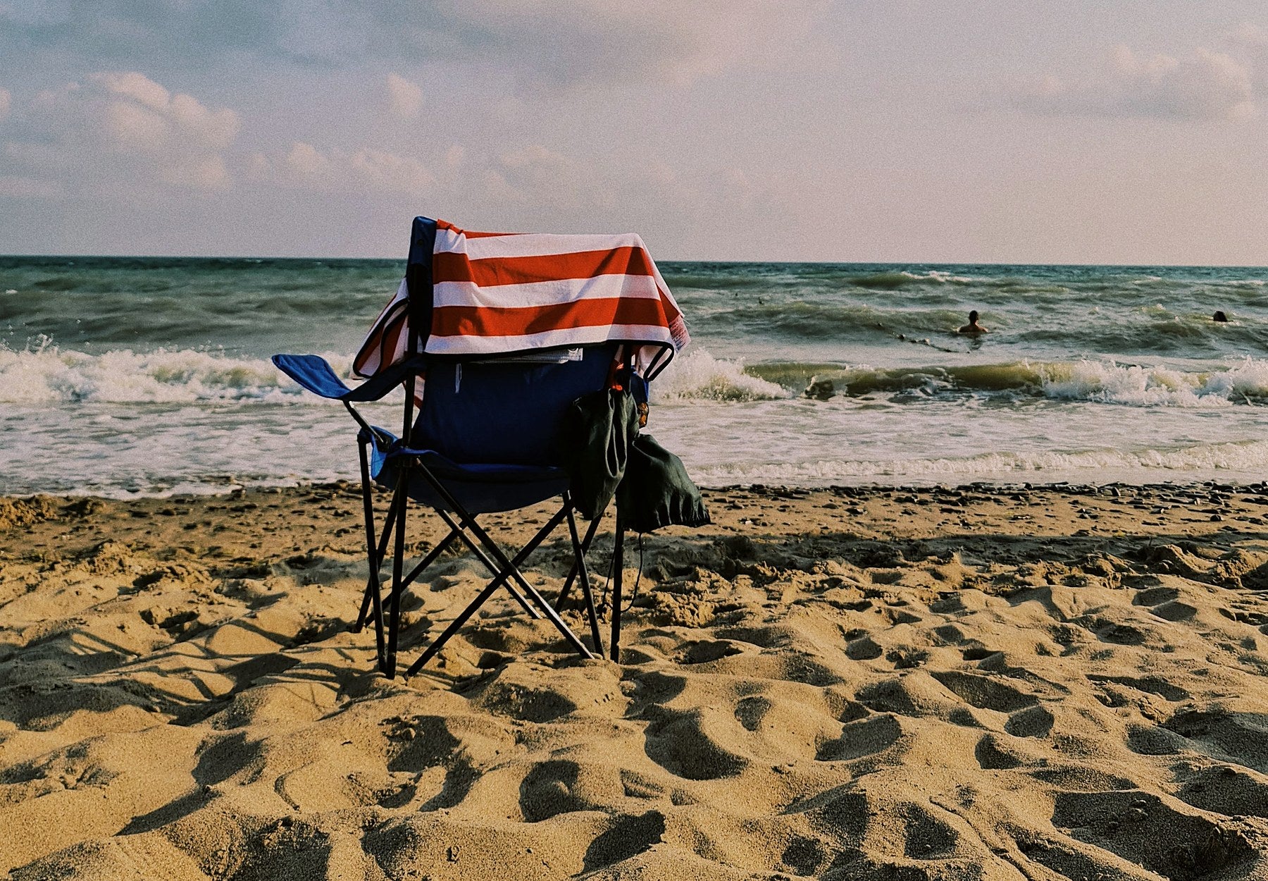 Portable chair facing the sea on a sandy beach